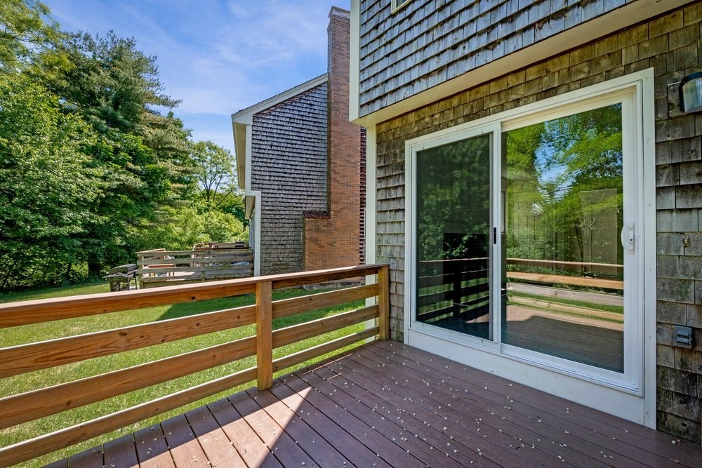 the deck of a home with a sliding glass patio door