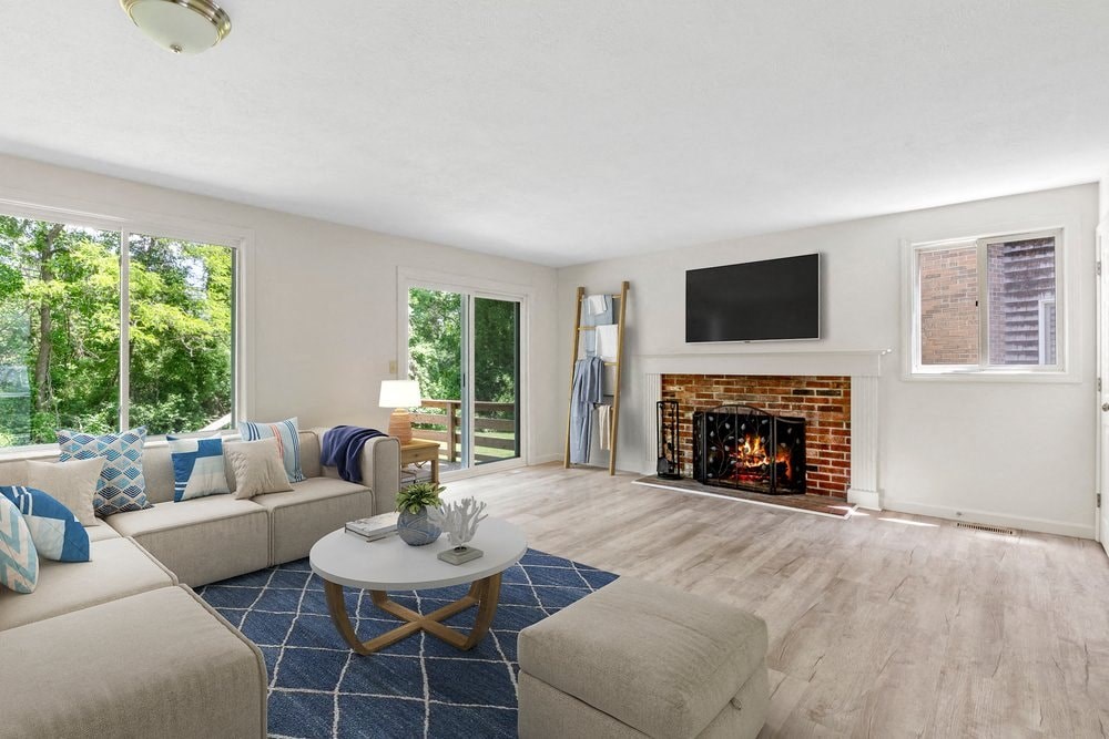 a living room with a couch and a coffee table and a fireplace