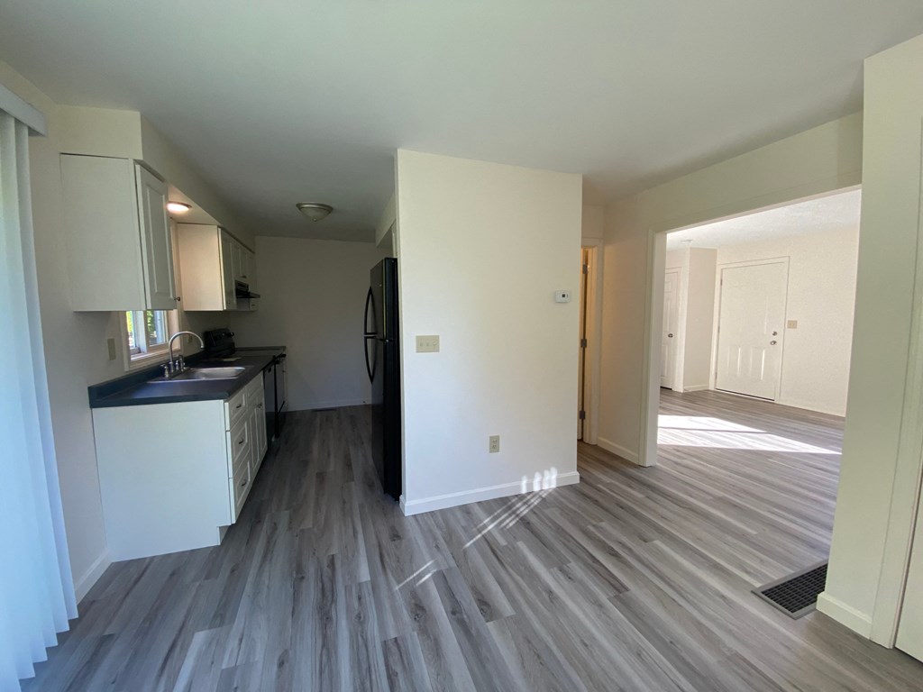 a view of a kitchen and living room in an empty apartment