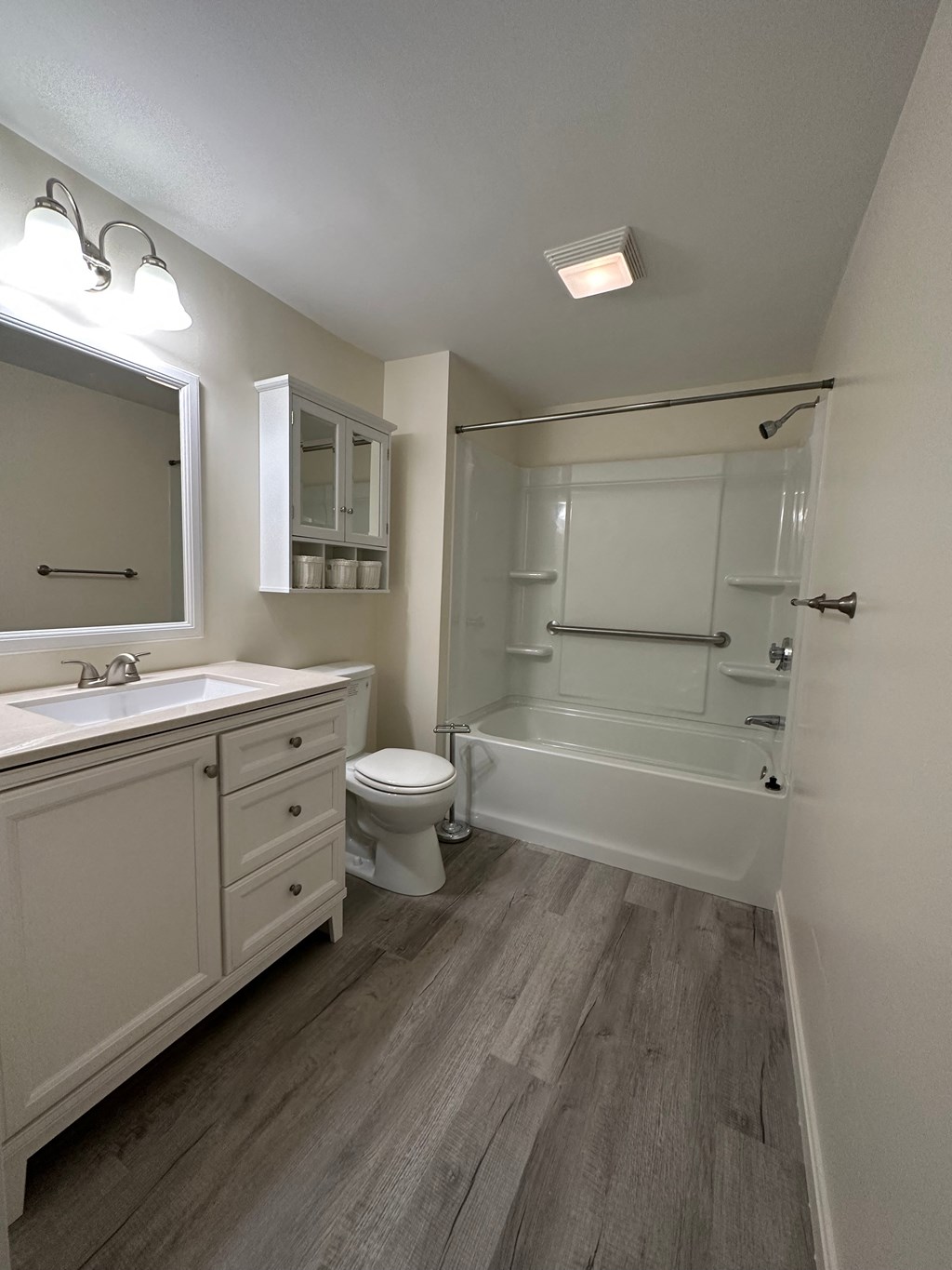 a bathroom with a shower toilet sink and mirror