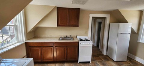 a small kitchen with a sink and a refrigerator