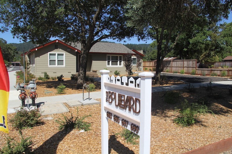 a house with a yard sign in front of it