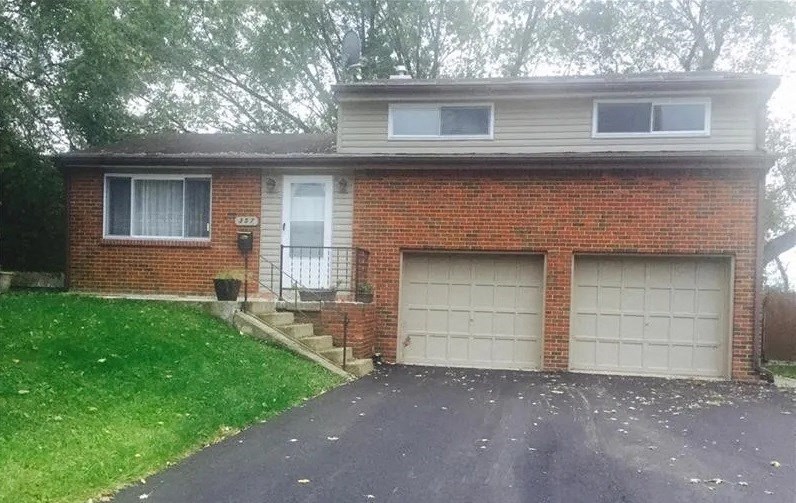 A two-story house with a garage door.