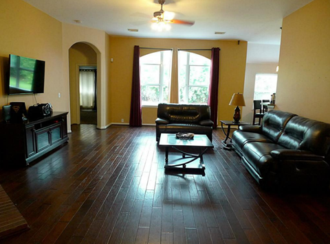 a living room with leather furniture and a television