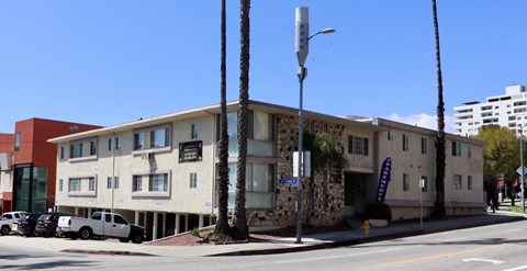 an apartment building on the corner of a street