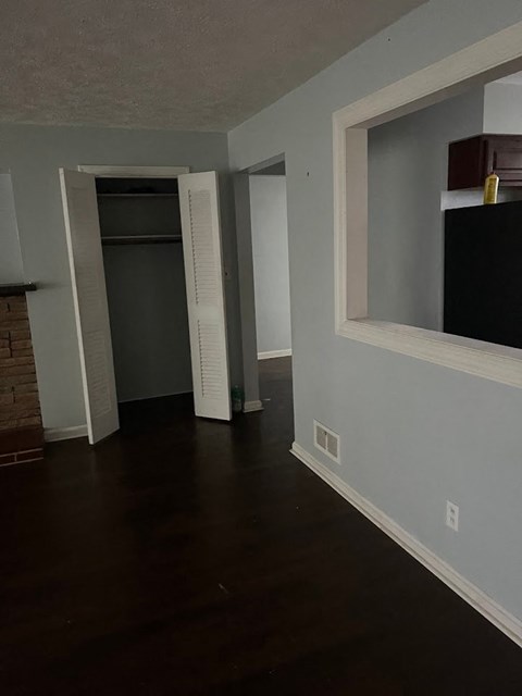 a living room with a window and a door to a closet