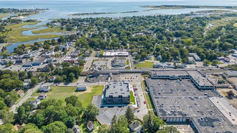 an aerial view of a city with cars parked in a parking lot