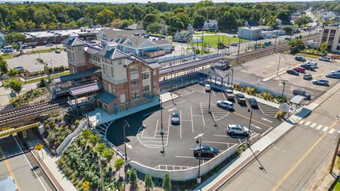 an aerial view of a city intersection with cars and a train