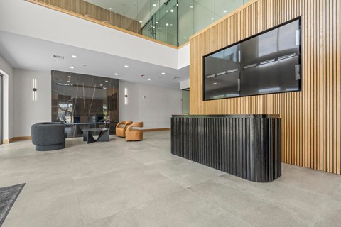 the lobby of an office building with a table and chairs