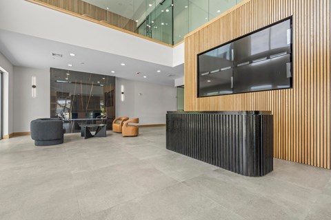 the lobby of an office building with a large screen on the wall