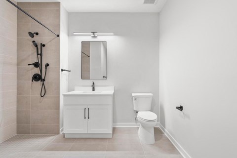 a white bathroom with a sink toilet and shower