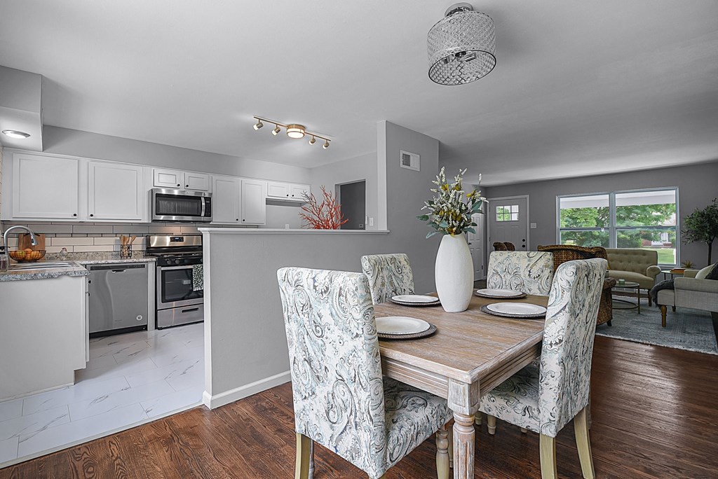 a kitchen and dining room with a table and chairs