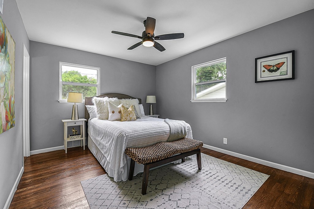 a bedroom with a bed and a ceiling fan