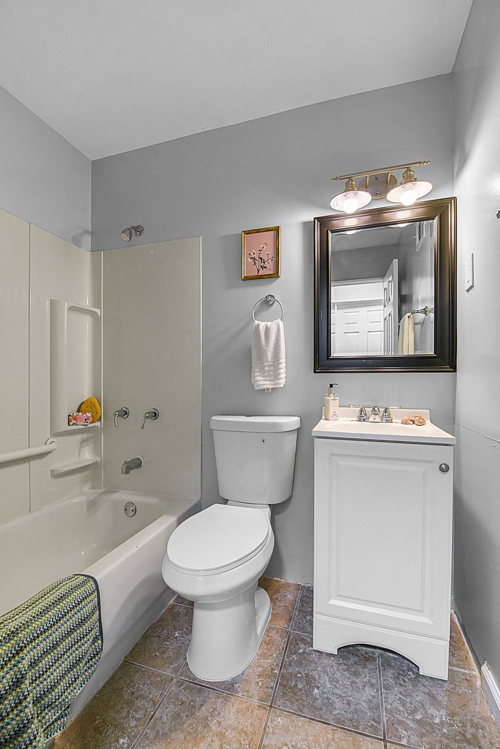 a bathroom with a white toilet and a tub and a sink