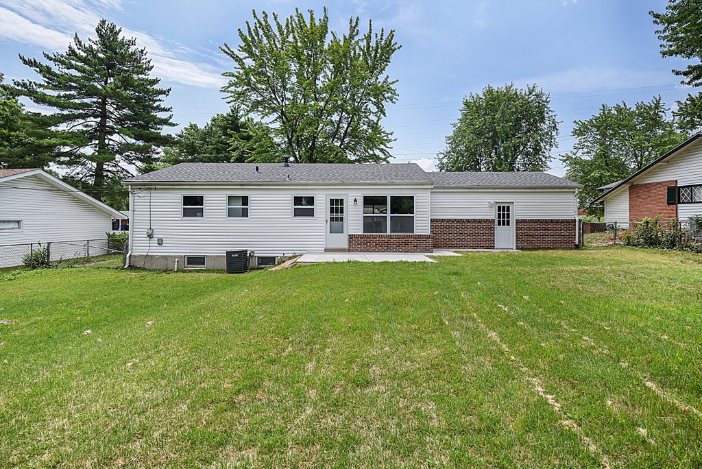 a white house with a yard in front of it