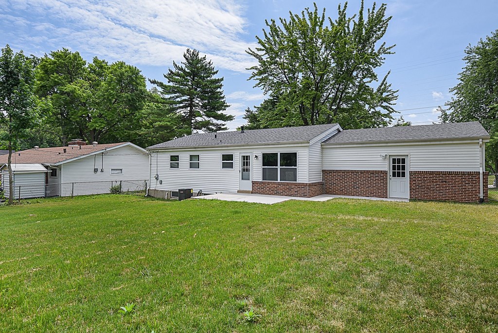 a white house with a yard in front of it