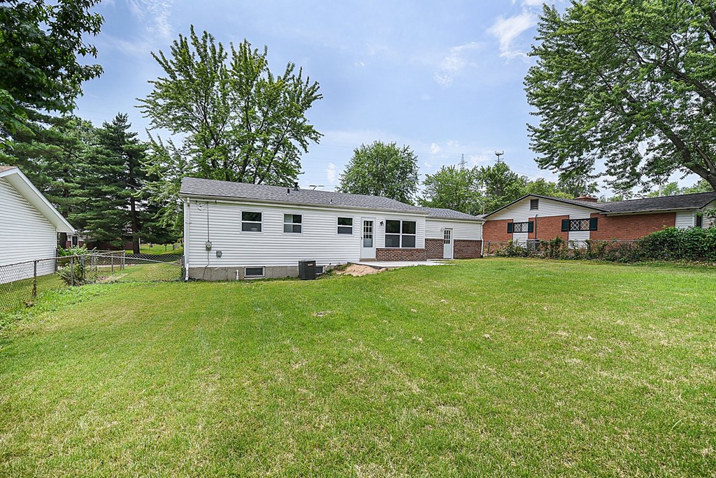 a white house with a yard in front of it