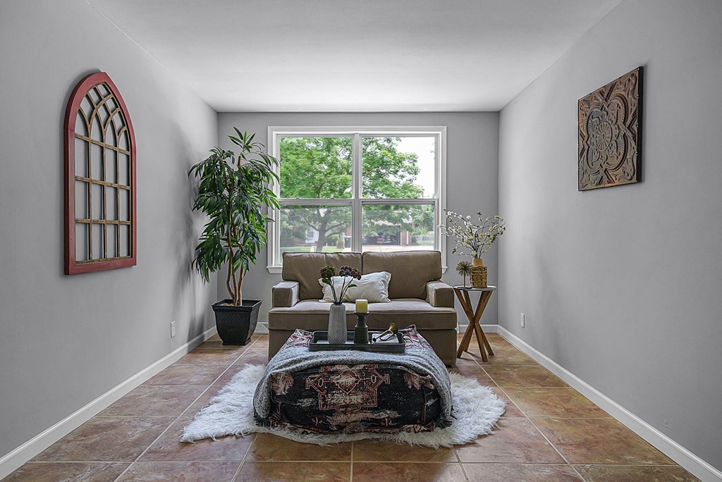 a living room with a couch and a window