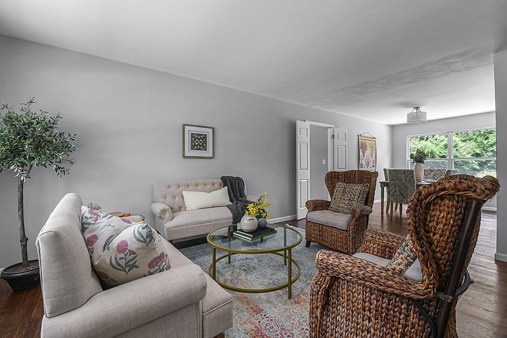 a living room with couches and chairs and a table