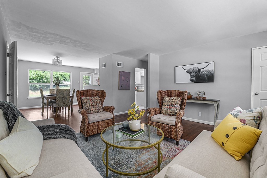 a living room with couches and chairs and a glass table