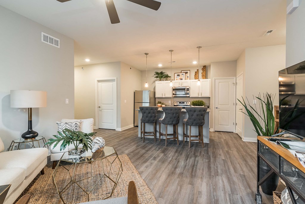 a living room and kitchen with a table and chairs