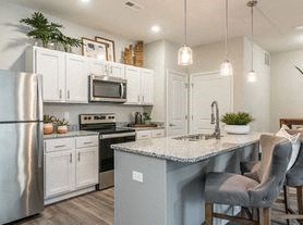 a kitchen with a counter top and a refrigerator