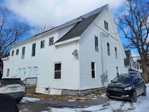 a white church with cars parked in front of it