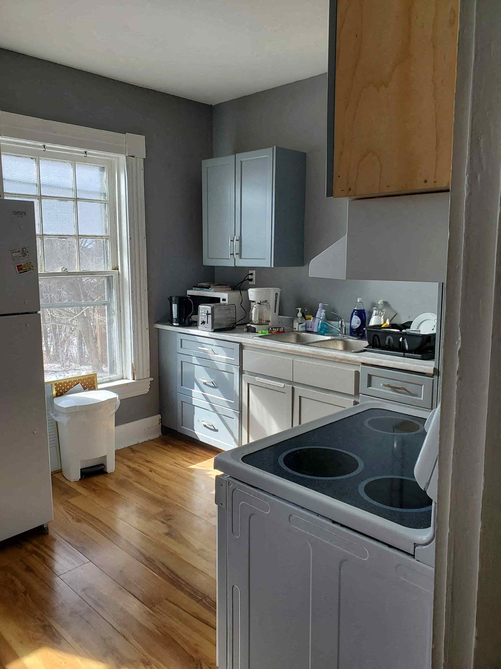 a kitchen with white cabinets and a stove