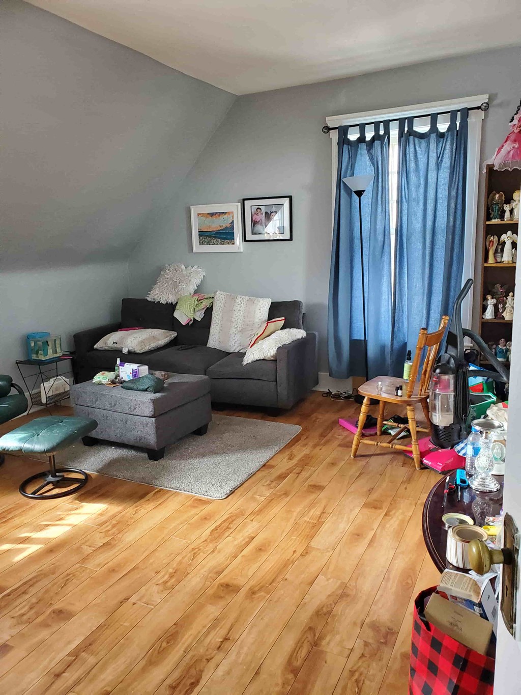 a living room with a couch and a wooden floor