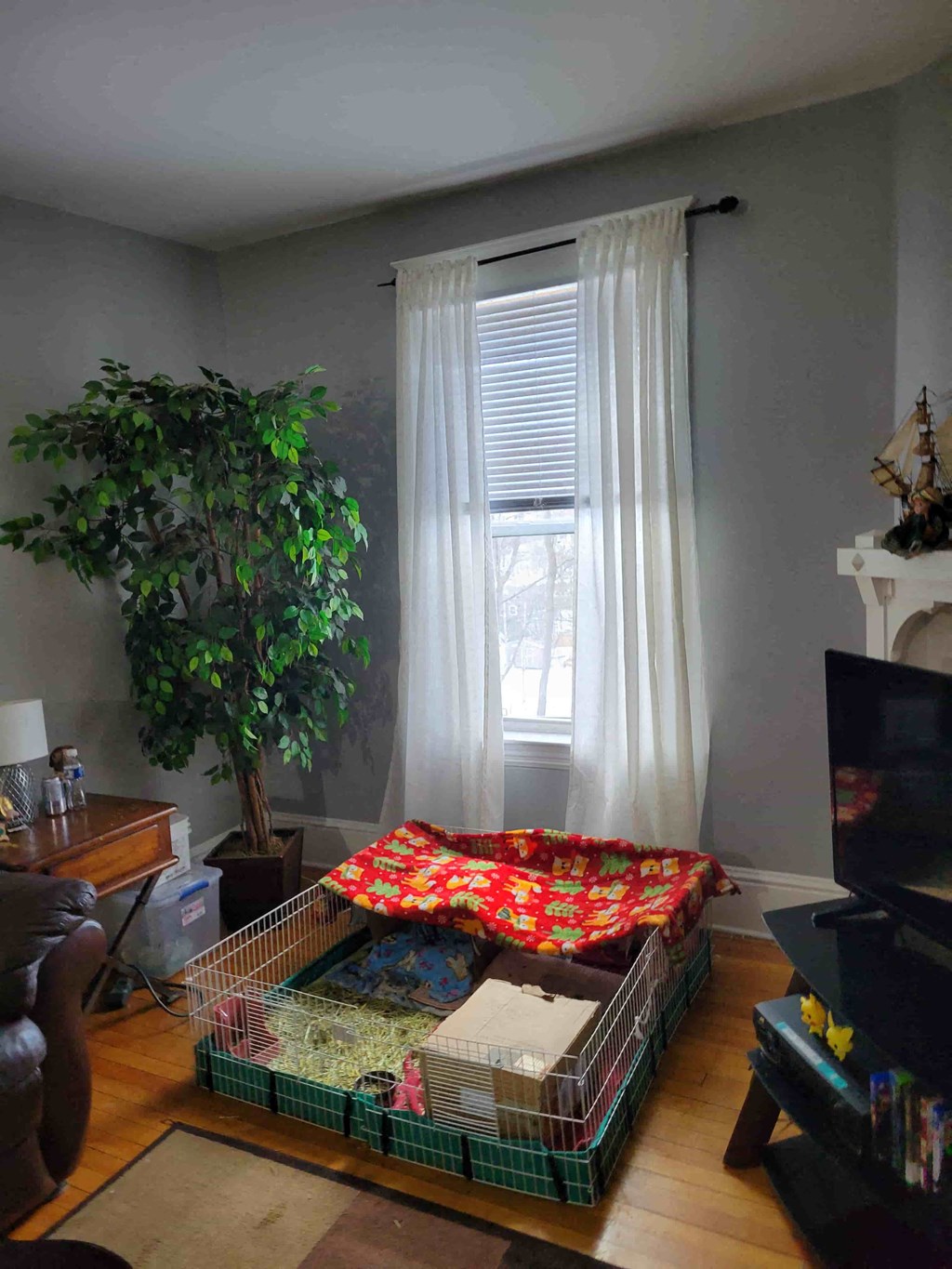 a living room with a bed in the corner