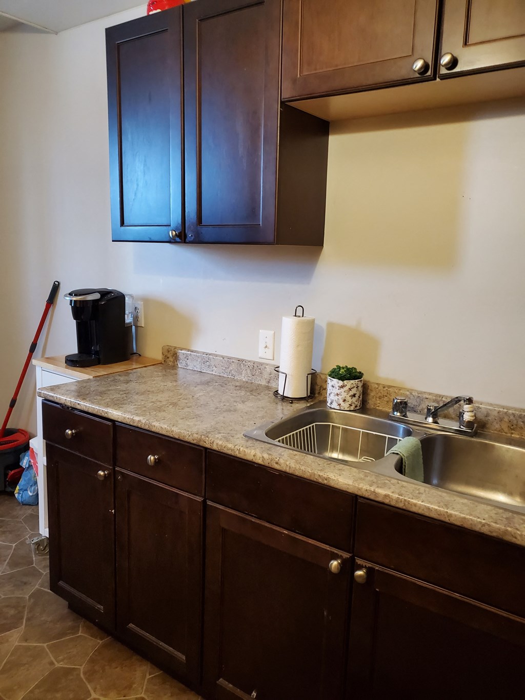 a kitchen with a sink and wooden cabinets