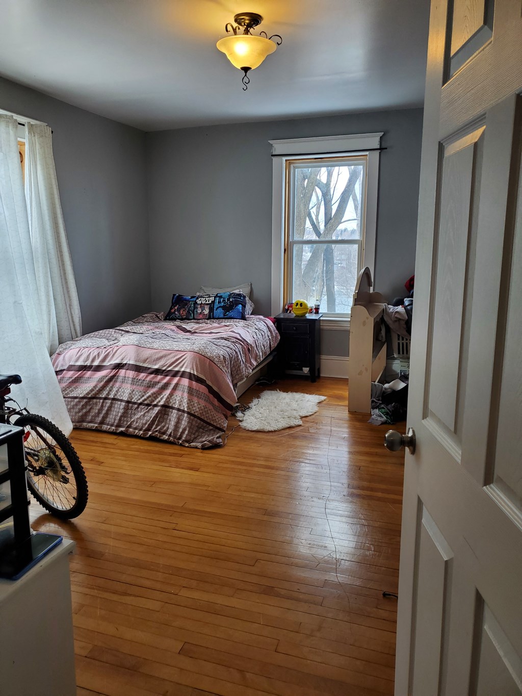 a bedroom with a bed and a window