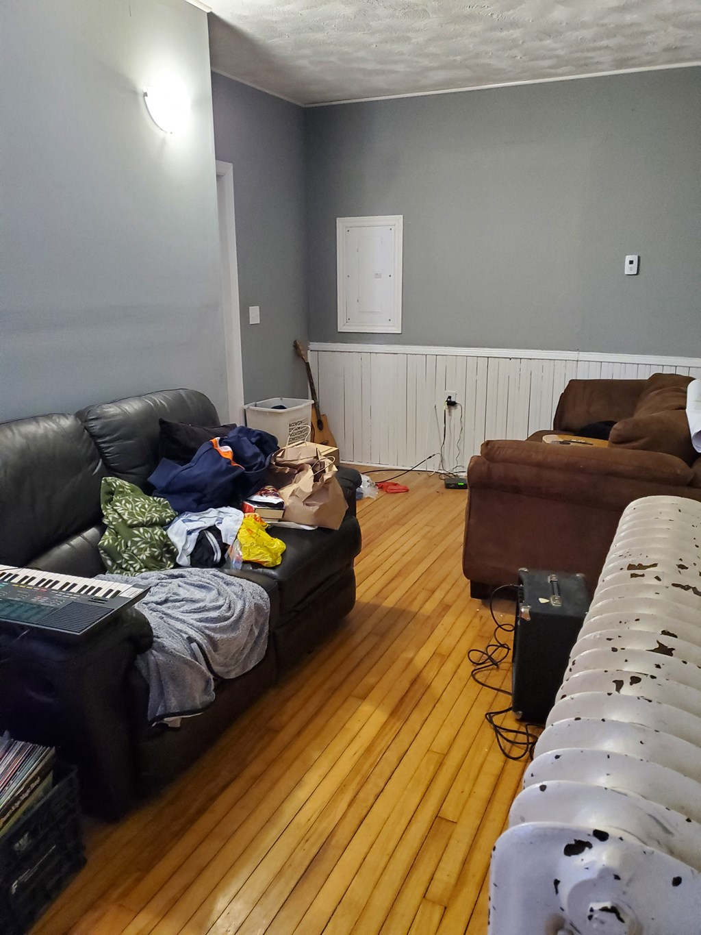 a living room filled with furniture and a wooden floor
