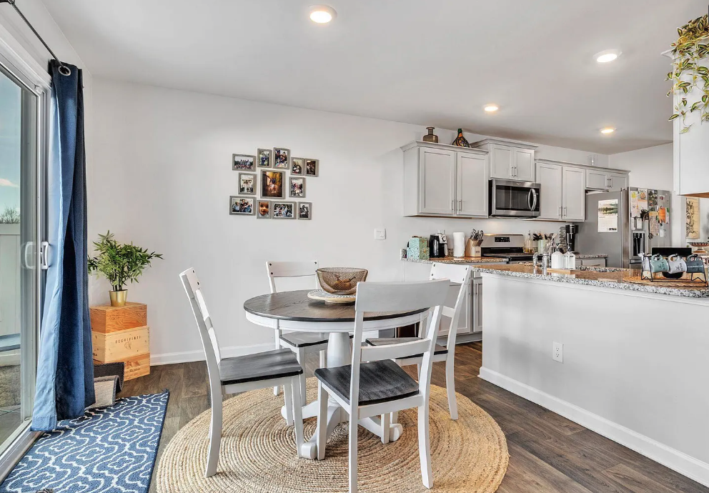 a kitchen and dining room with a table and chairs