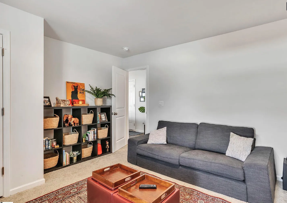 a living room with a couch and a book shelf