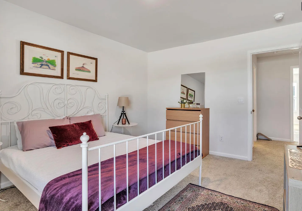 a bedroom with a bed and a door to a bathroom