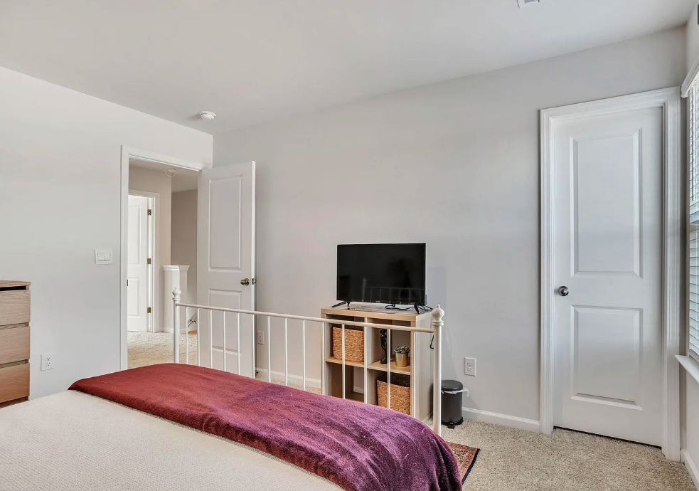 a bedroom with a bed and a tv