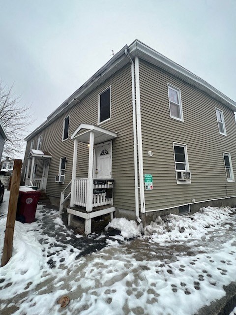 A house with a brown siding and a white door.