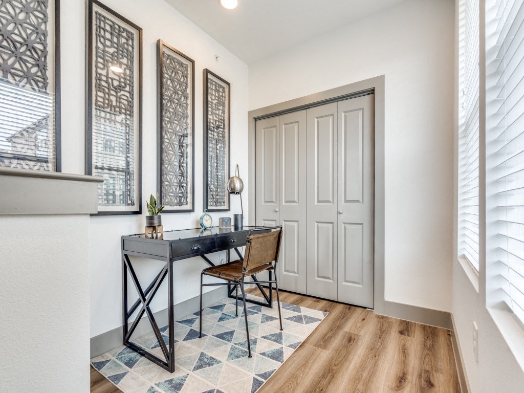 an office with white walls and a desk with a chair