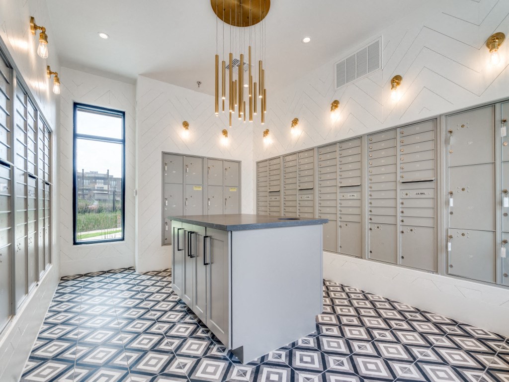 a large locker room with lockers and a counter in the center of the room