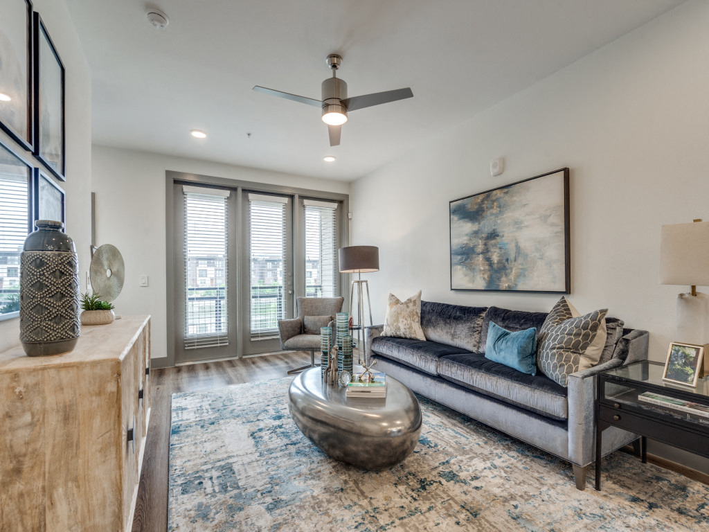 a living room with a couch and a ceiling fan