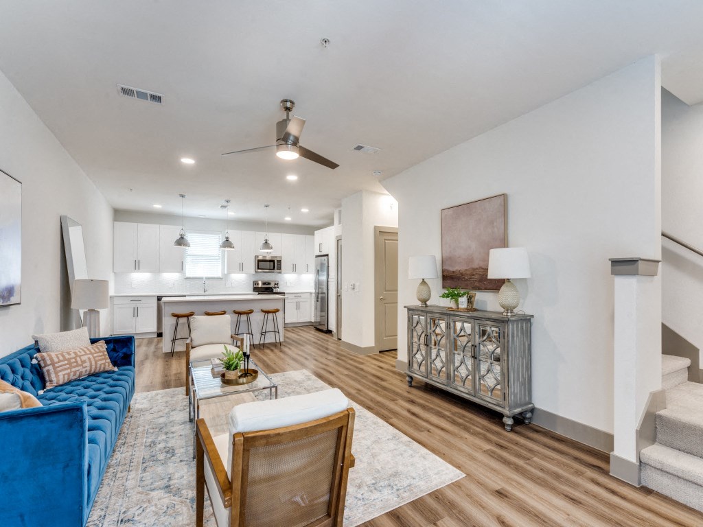 a living room and kitchen with a couch and a table