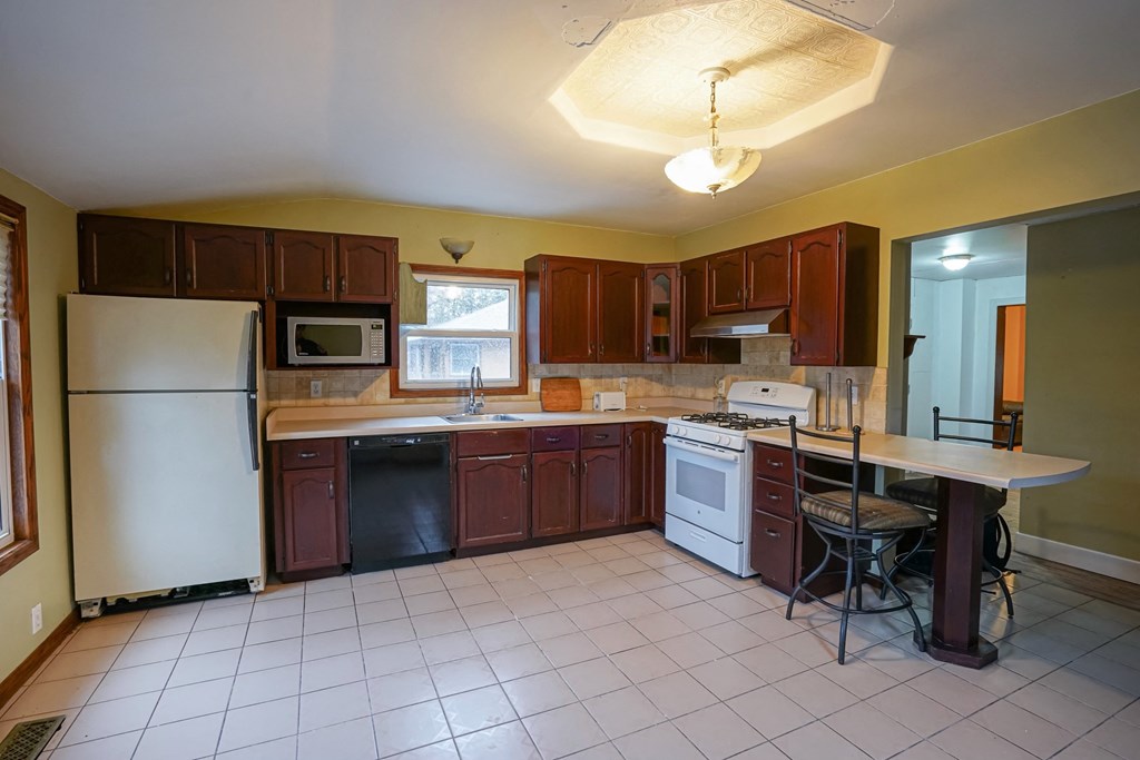 a kitchen with a island and a stove and a refrigerator
