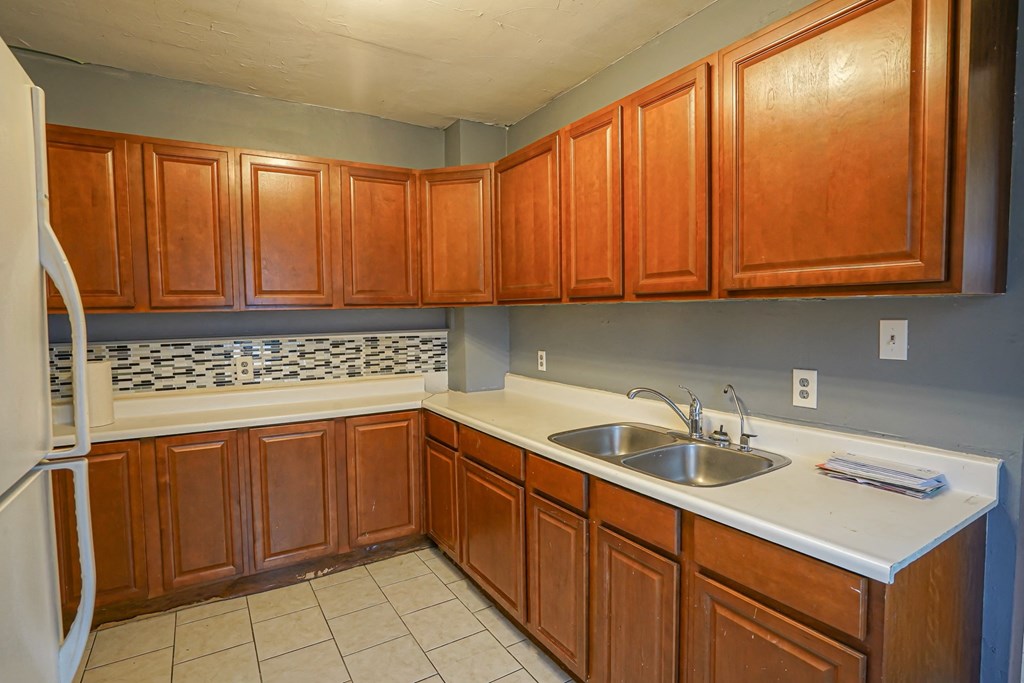 a kitchen with wooden cabinets and a sink