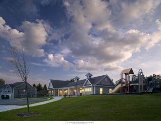 a rendering of a house with a playground in front of it