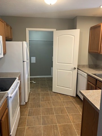 A kitchen with a white refrigerator and a white door.