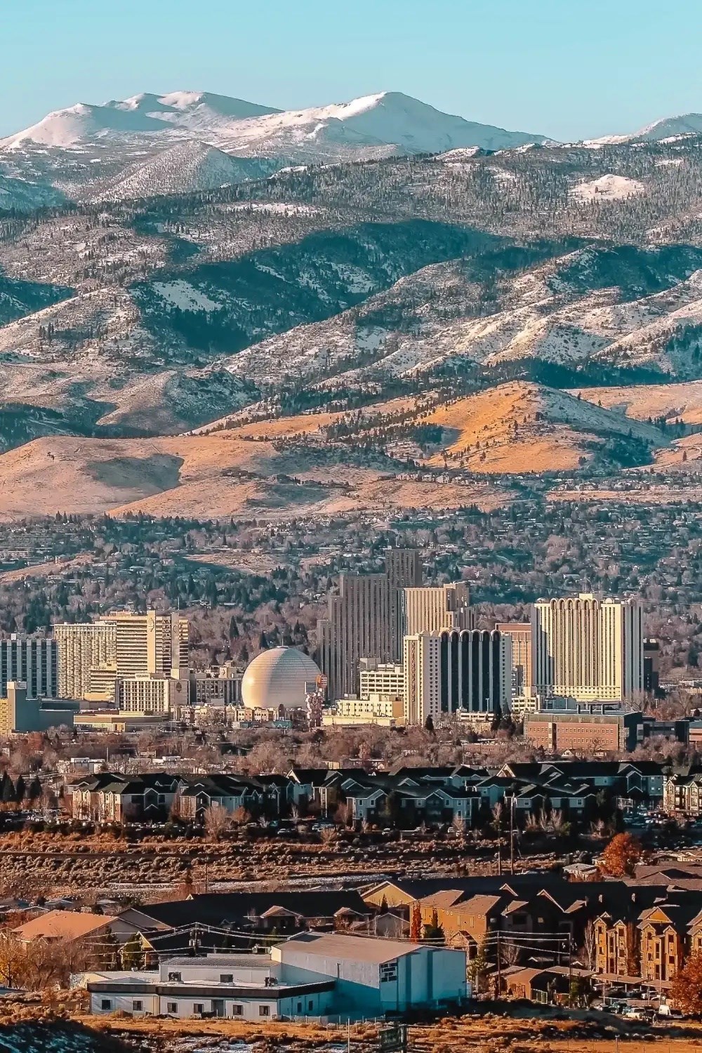 the city with the mountains in the background