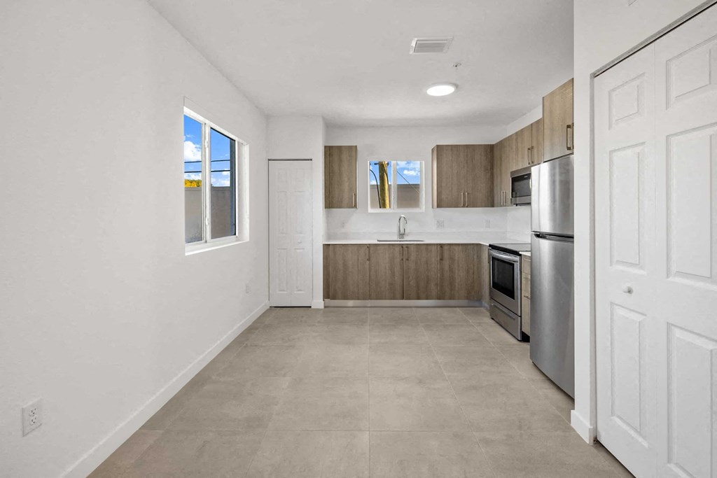 a kitchen with stainless steel appliances and wooden cabinets