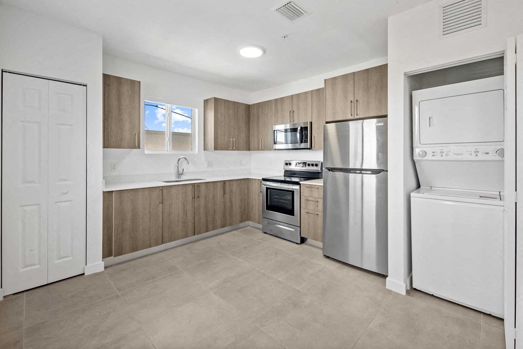 a kitchen with stainless steel appliances and wooden cabinets