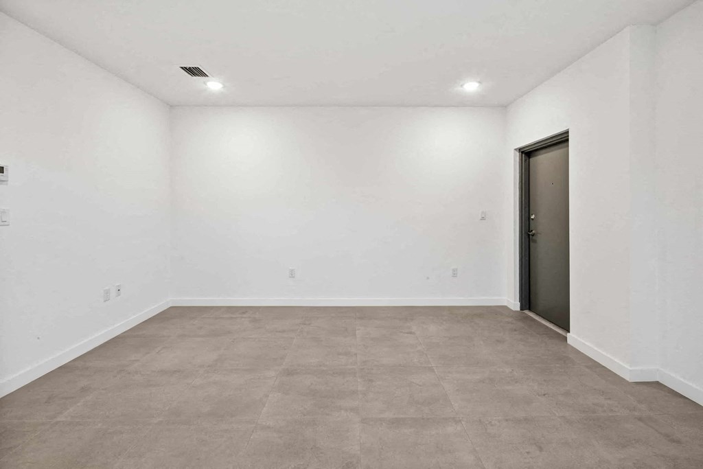 a room with a white wall and a door